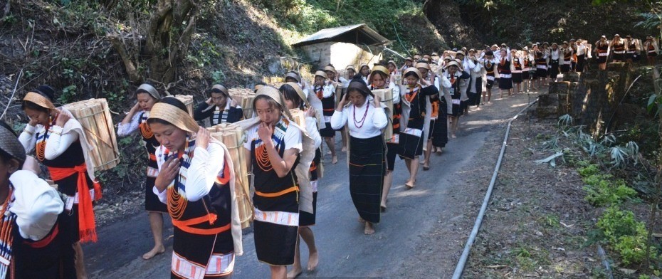People take part in the Millie Rahzhe, an age-old practice where all abled-citizens of the village come together and carry firewood, at Kami village, Phek on December 23. (DIPR Photo)